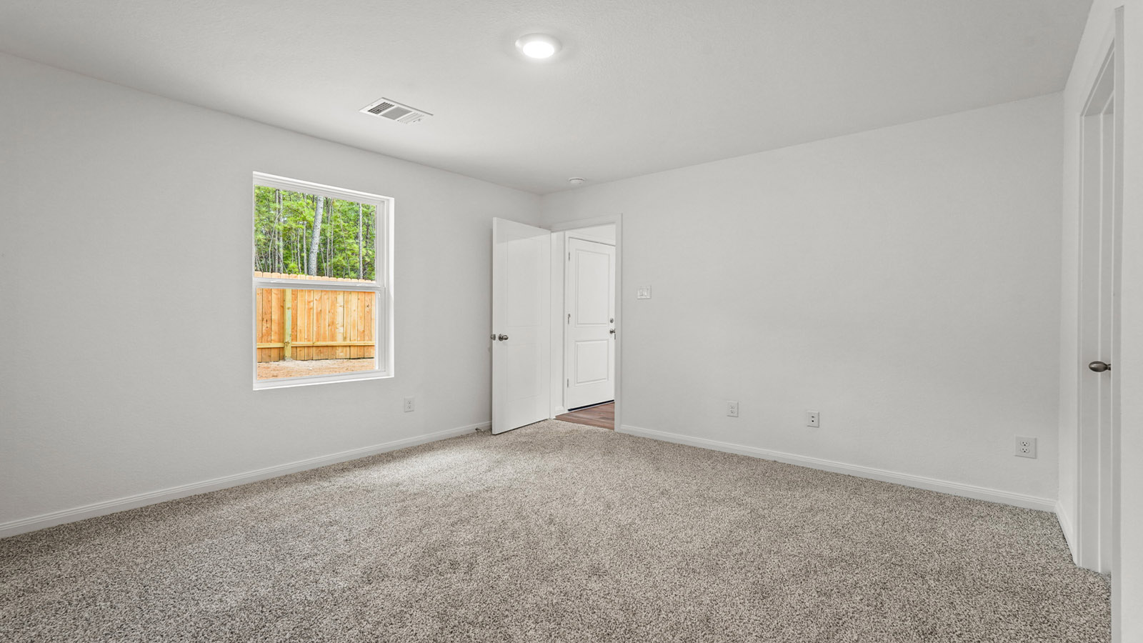 Primary bedroom with carpet flooring
