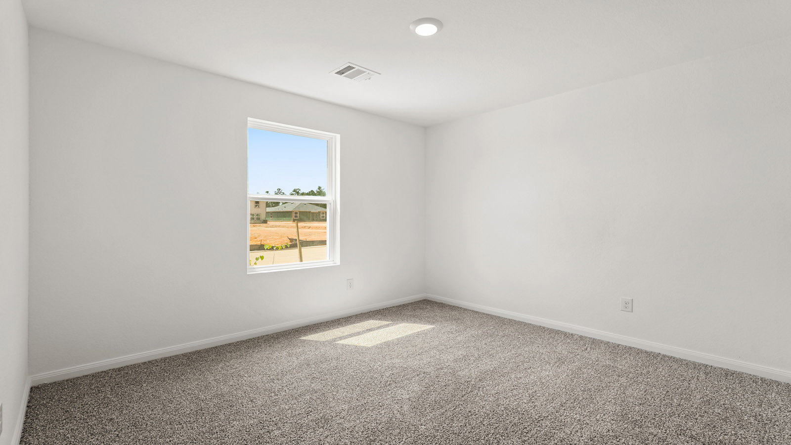 Secondary bedroom with carpet flooring