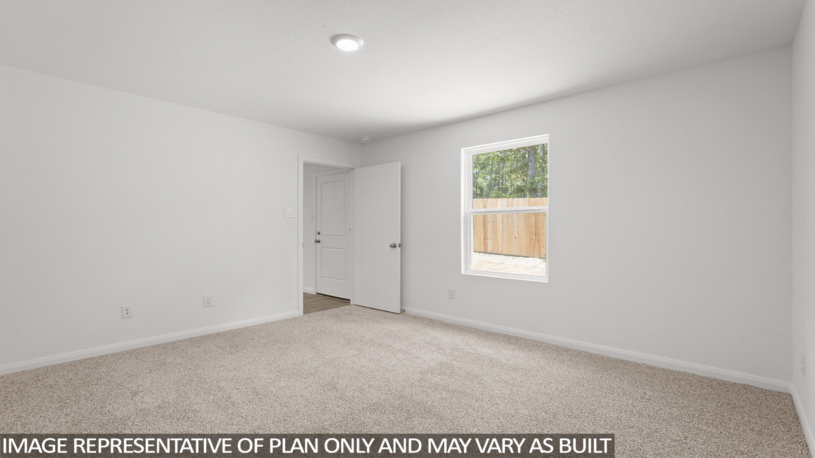 Primary bedroom with carpet flooring