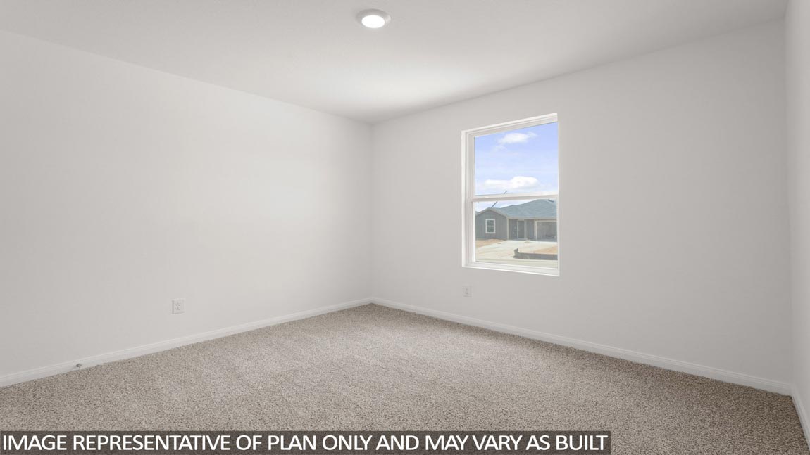 Secondary bedroom with carpet flooring
