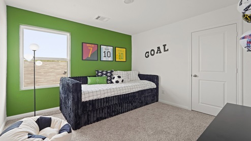 Secondary bedroom with carpet flooring