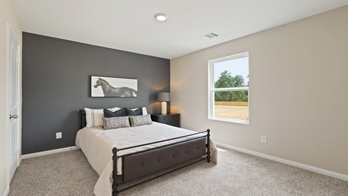 Secondary bedroom with carpet flooring