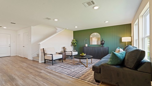 Spacious living area with vinyl flooring