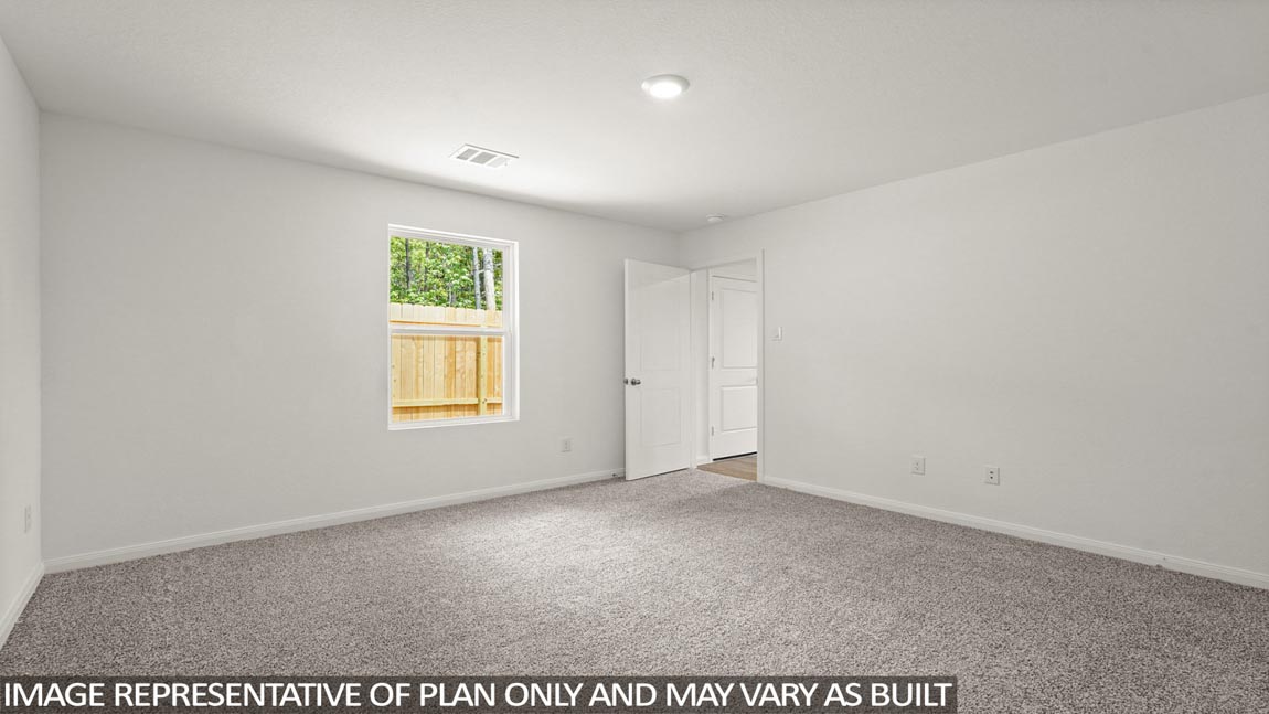 Primary bedroom with carpet flooring