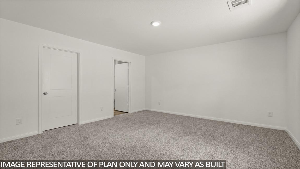 Primary bedroom with carpet flooring