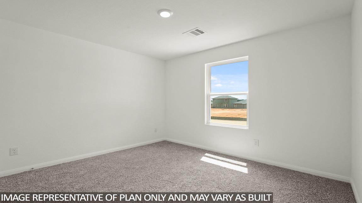 Secondary bedroom with carpet flooring