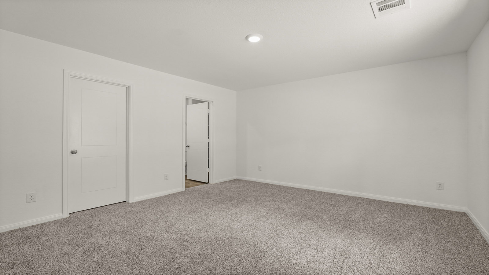 Primary bedroom with carpet flooring