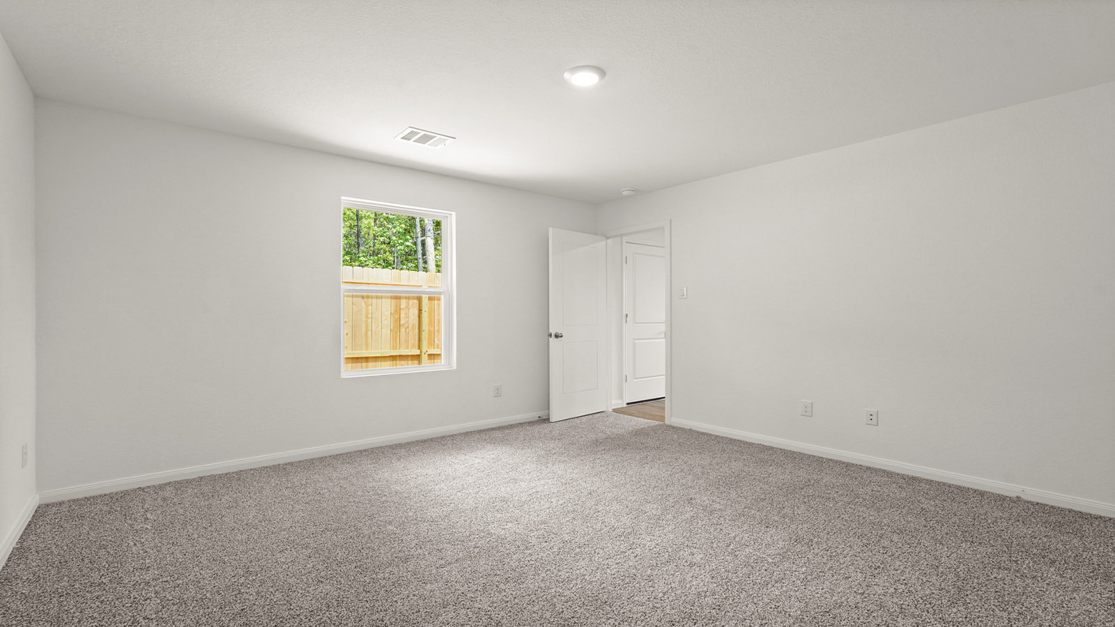 Primary bedroom with carpet flooring