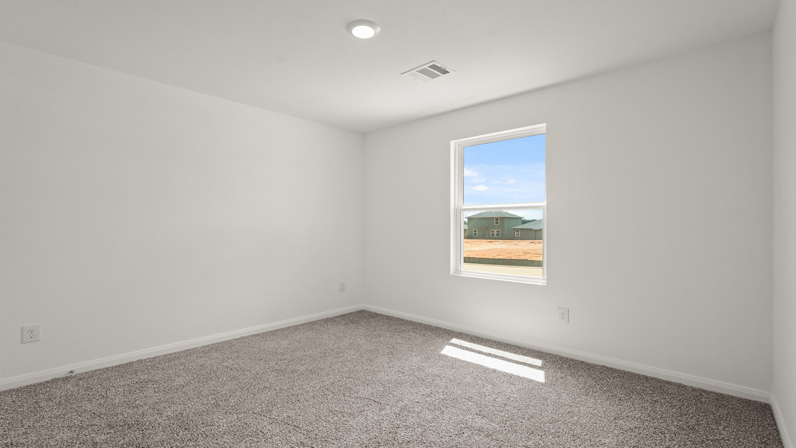 Secondary bedroom with carpet flooring