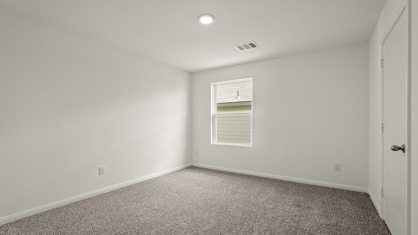 Secondary bedroom with carpet flooring