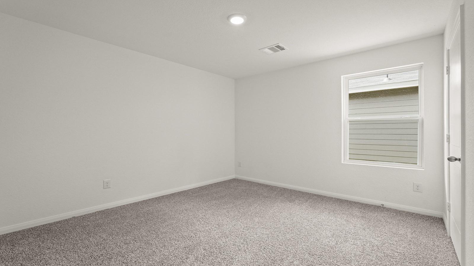 Secondary bedroom with carpet flooring