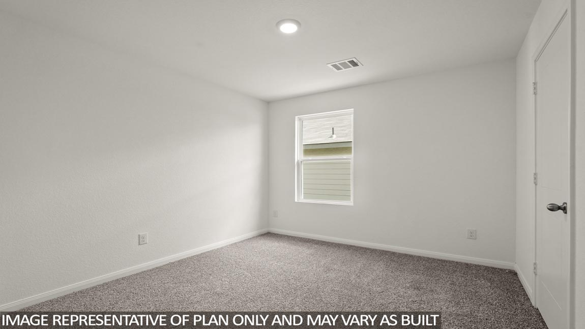 Secondary bedroom with carpet flooring