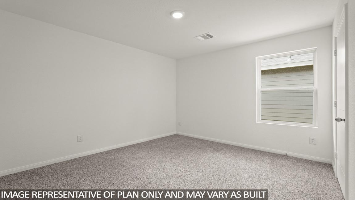 Secondary bedroom with carpet flooring