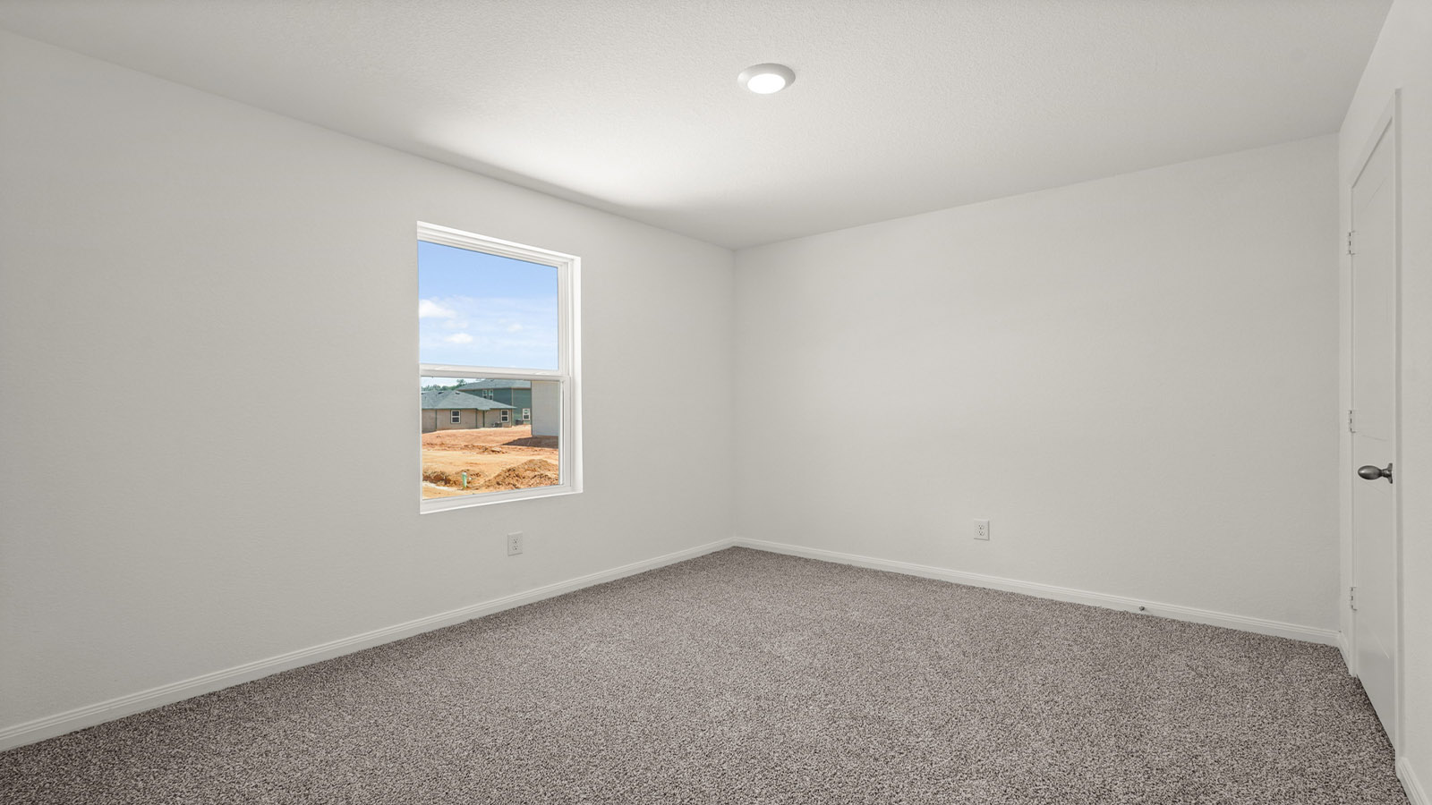 Secondary bedroom with carpet flooring