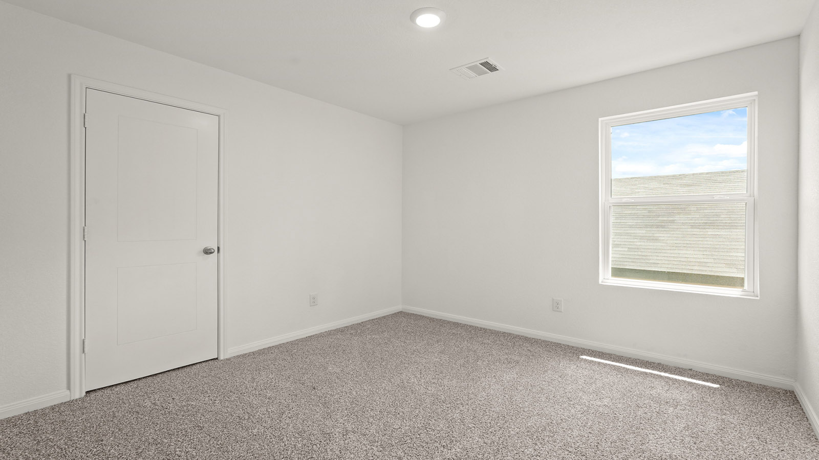 Secondary bedroom with carpet flooring