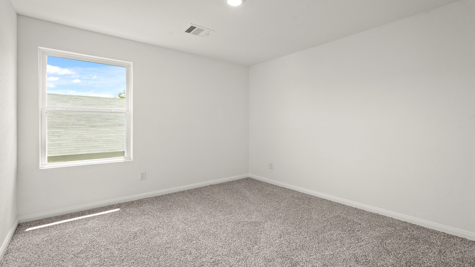 Secondary bedroom with carpet flooring