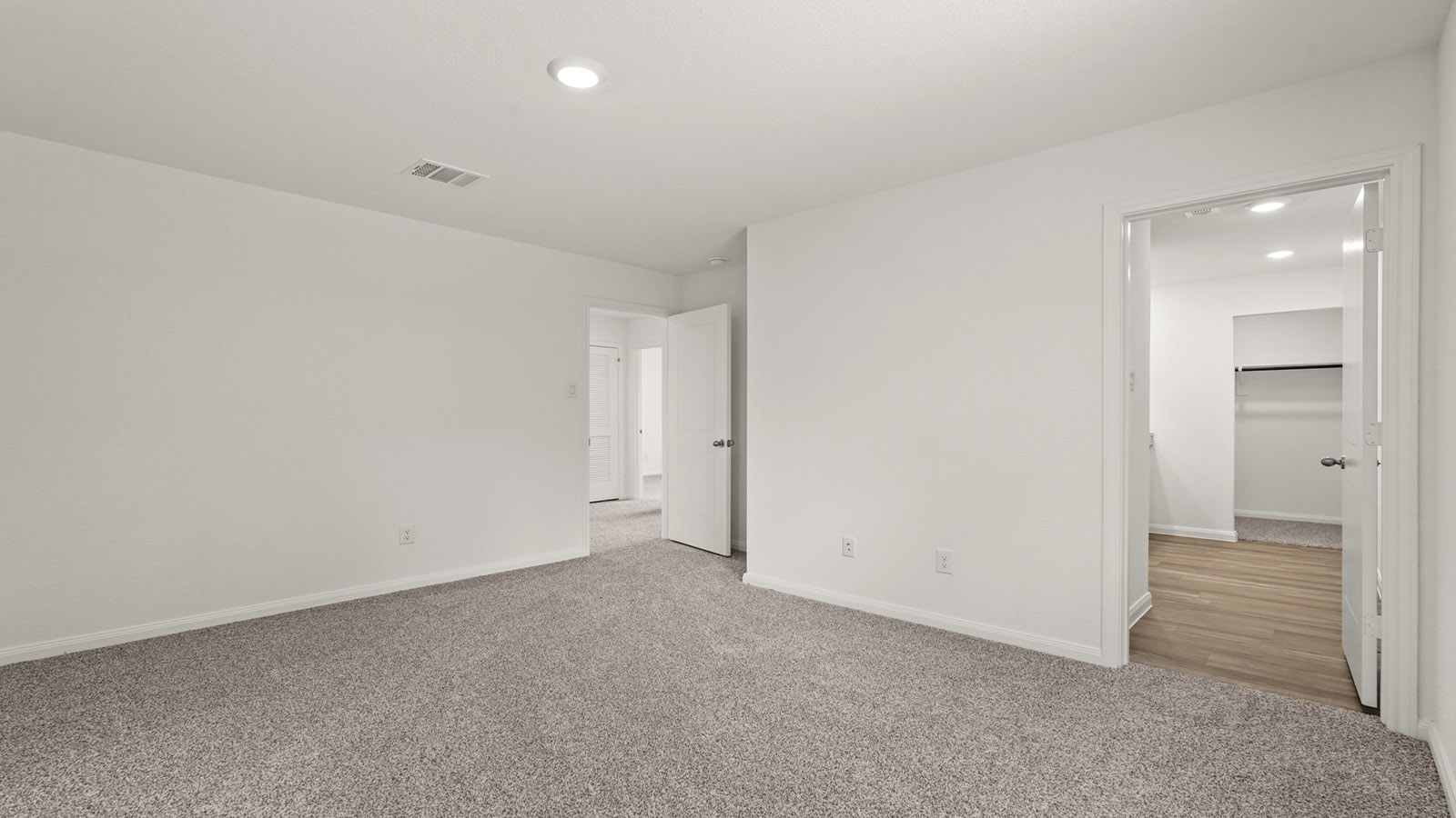 Primary bedroom with bright windows
