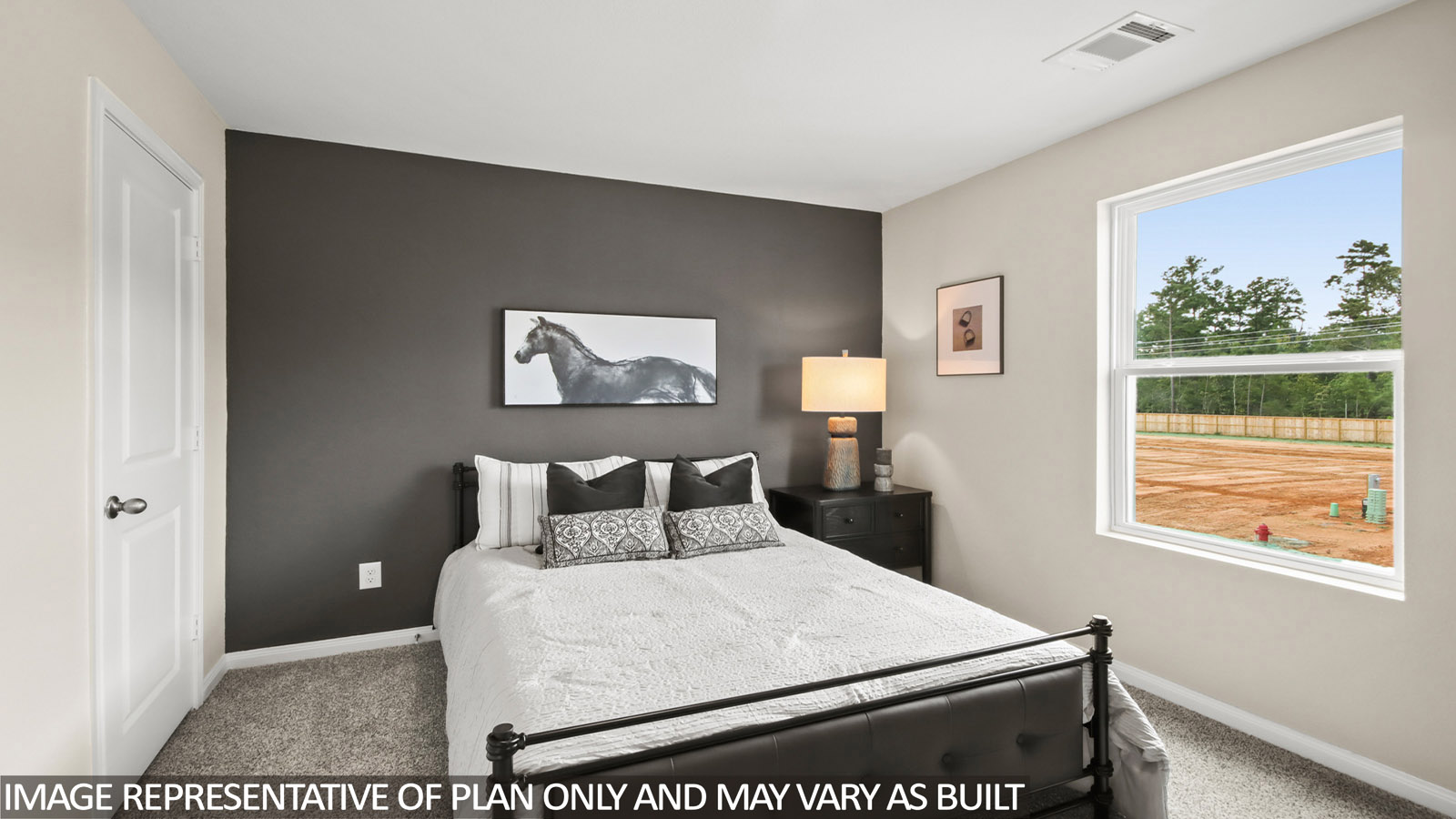 Secondary bedroom with carpet flooring