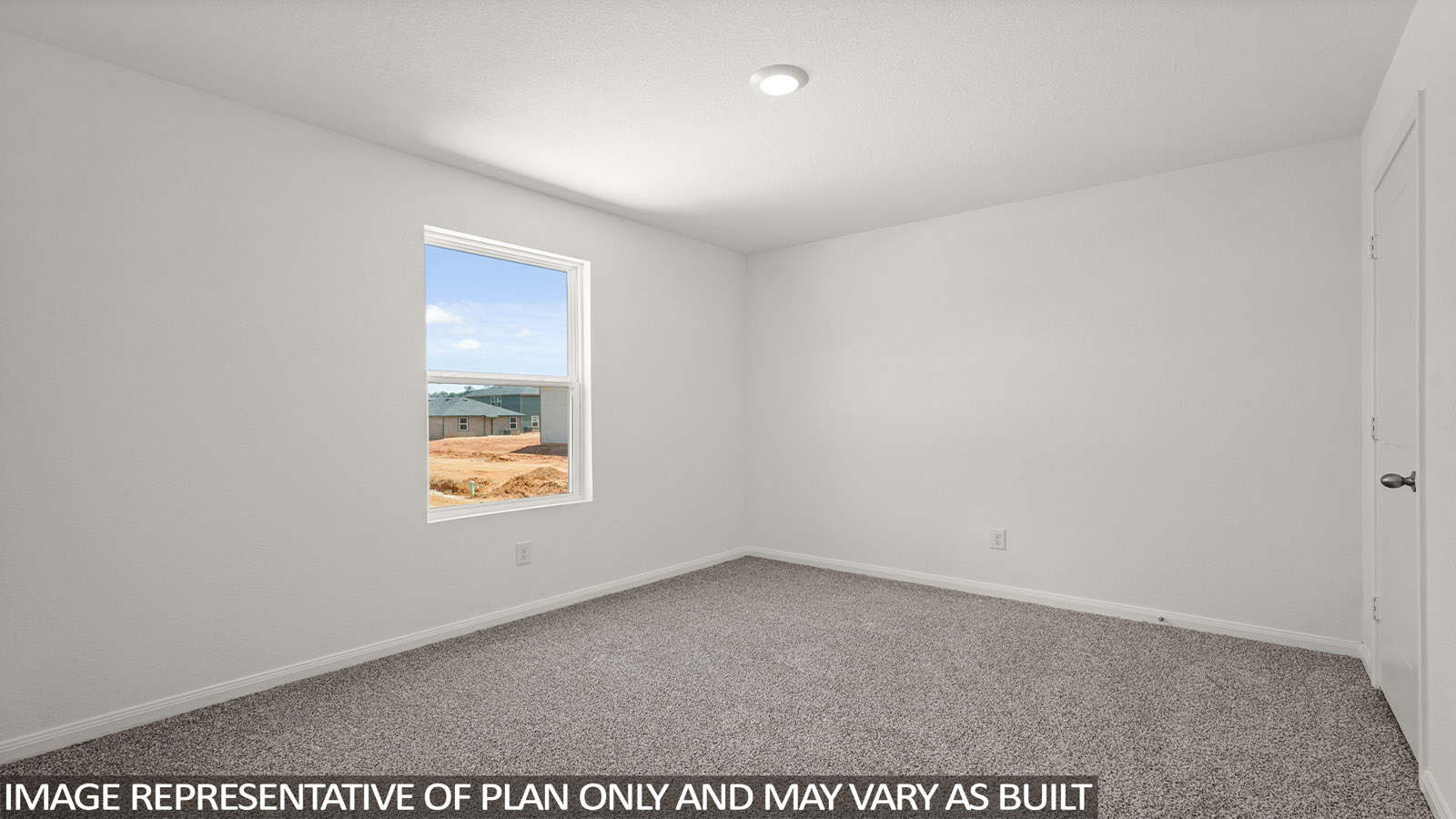 Secondary bedroom with carpet flooring