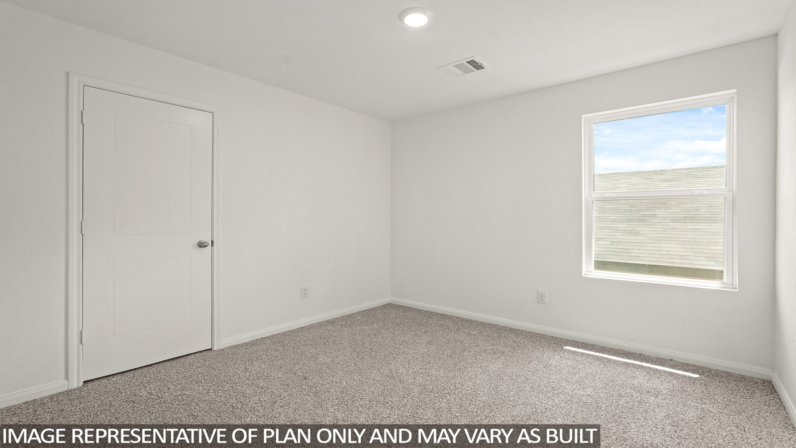 Secondary bedroom with carpet flooring