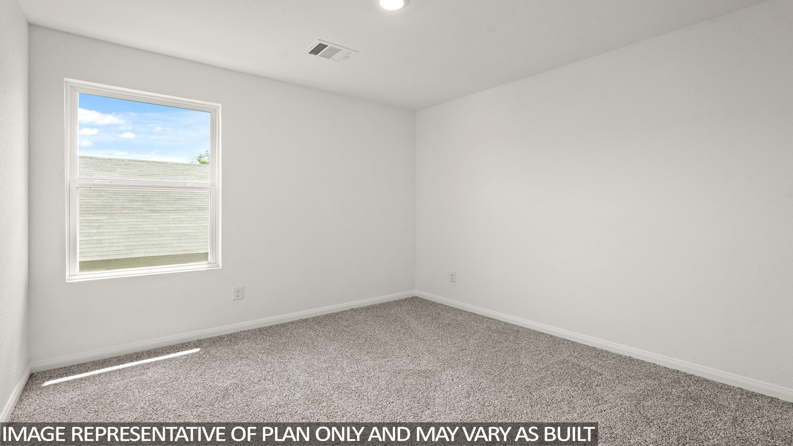 Secondary bedroom with carpet flooring