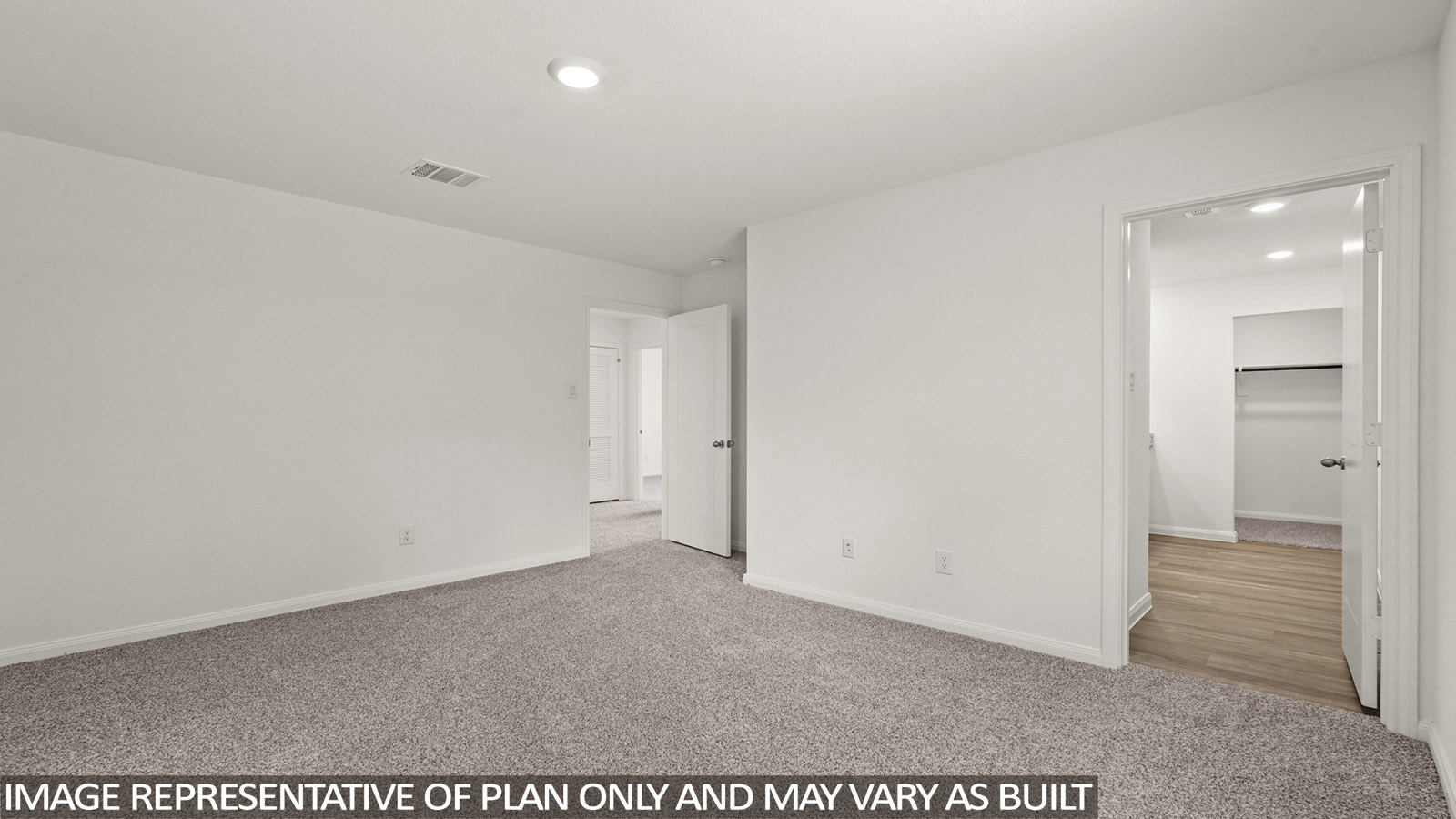 Primary bedroom with carpet flooring