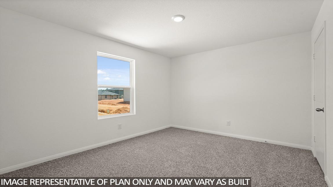 Secondary bedroom with carpet flooring