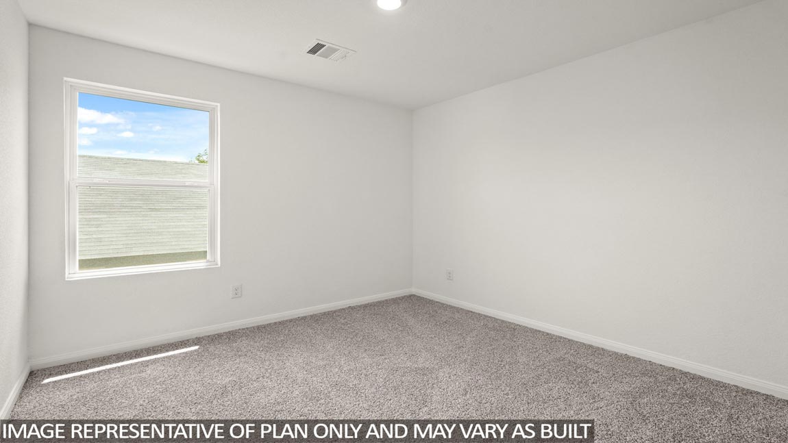 Secondary bedroom with carpet flooring