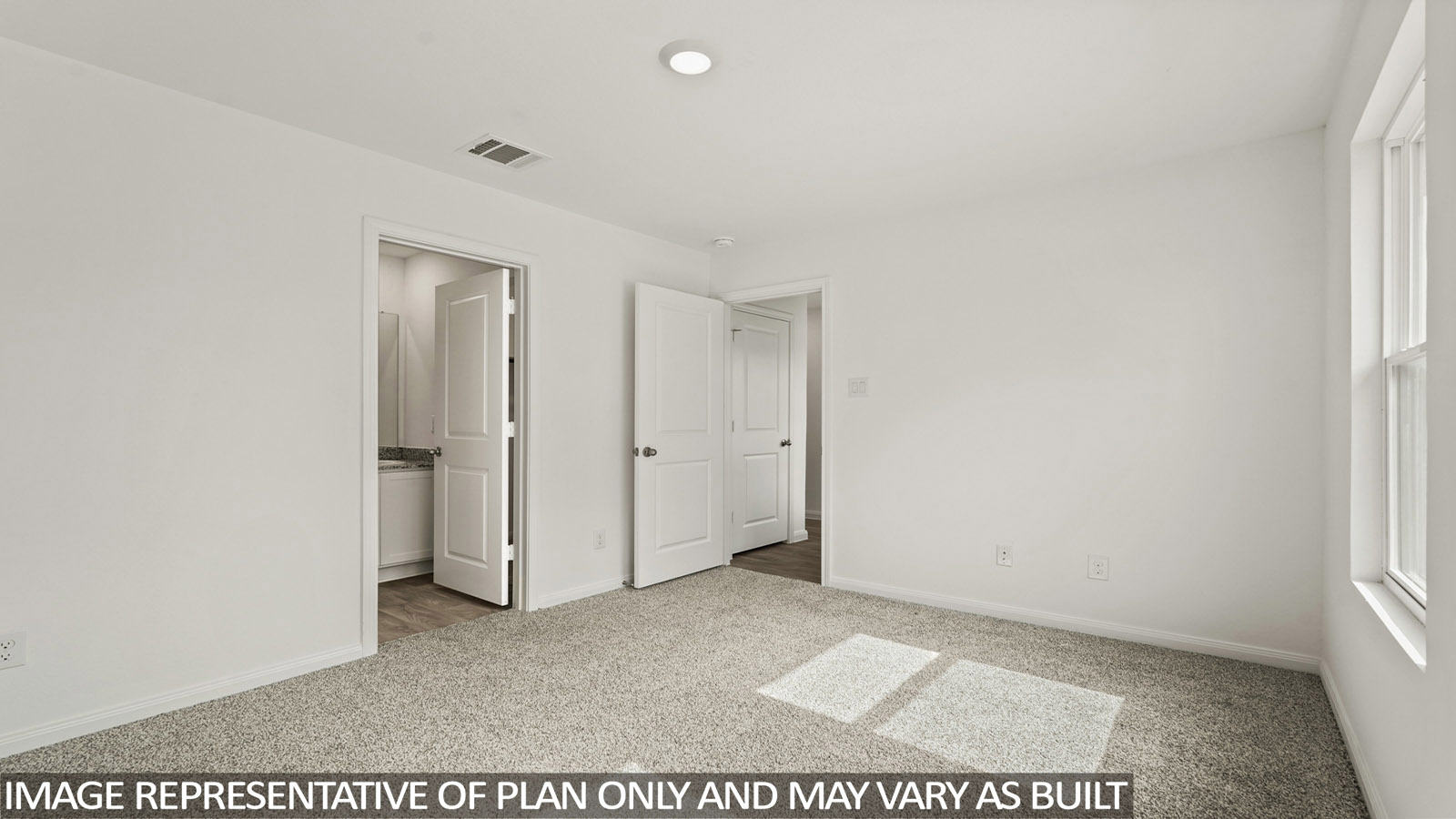 Primary bedroom with carpet flooring