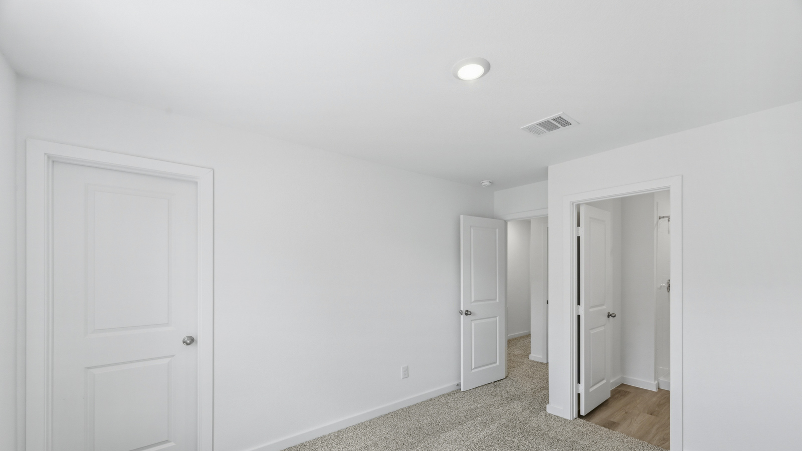 primary bedroom with carpet flooring