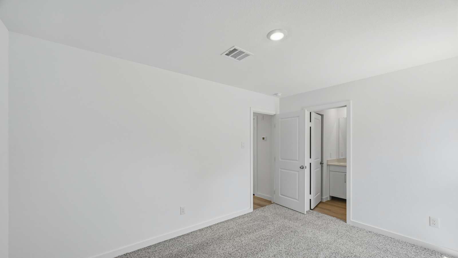 Primary bedroom with carpet flooring