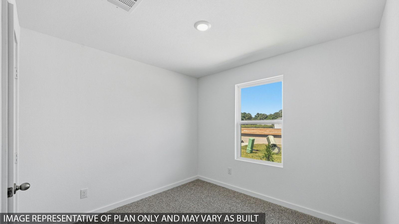 Secondary bedroom with carpet flooring