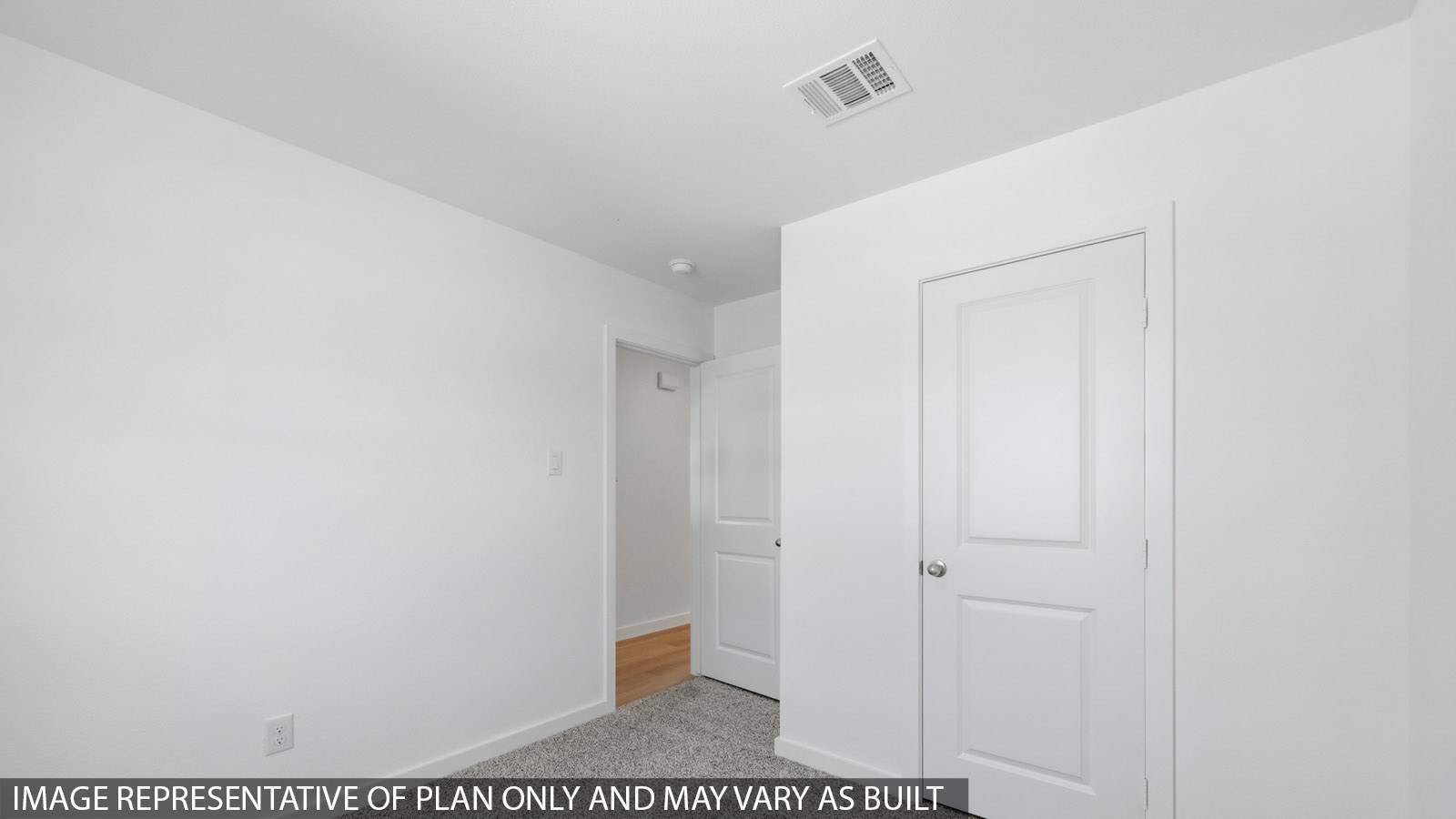 Secondary bedroom with carpet flooring