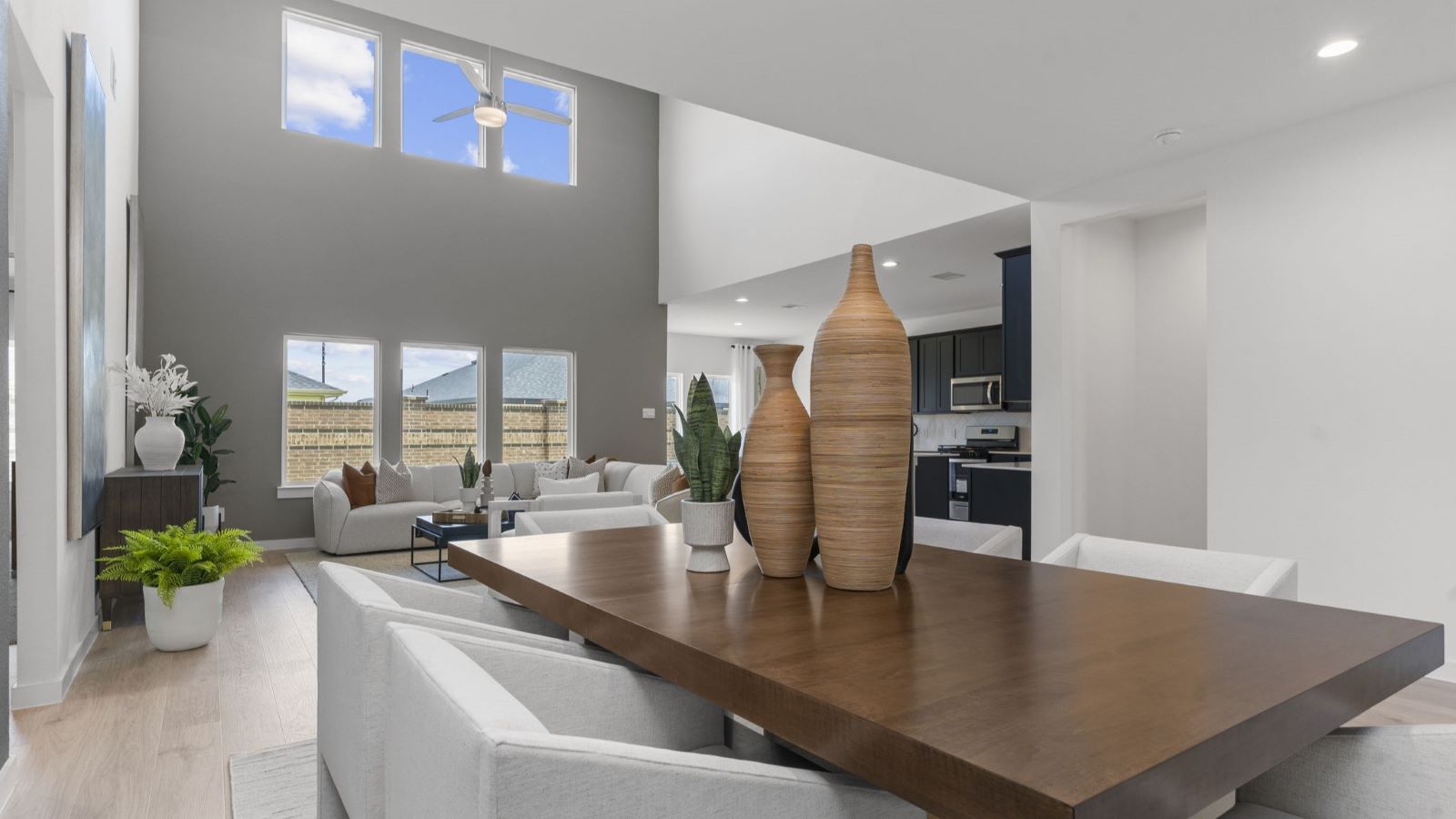 Spacious dining area with vinyl wood flooring, large window and tall ceiling
