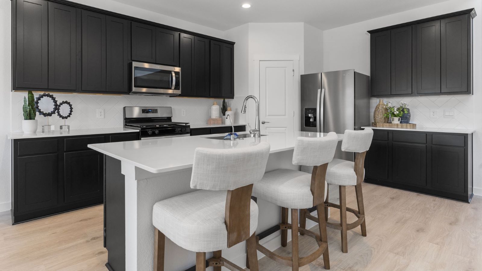 Kitchen with stainless steel appliances, shaker style cabinets, and elevated finishes