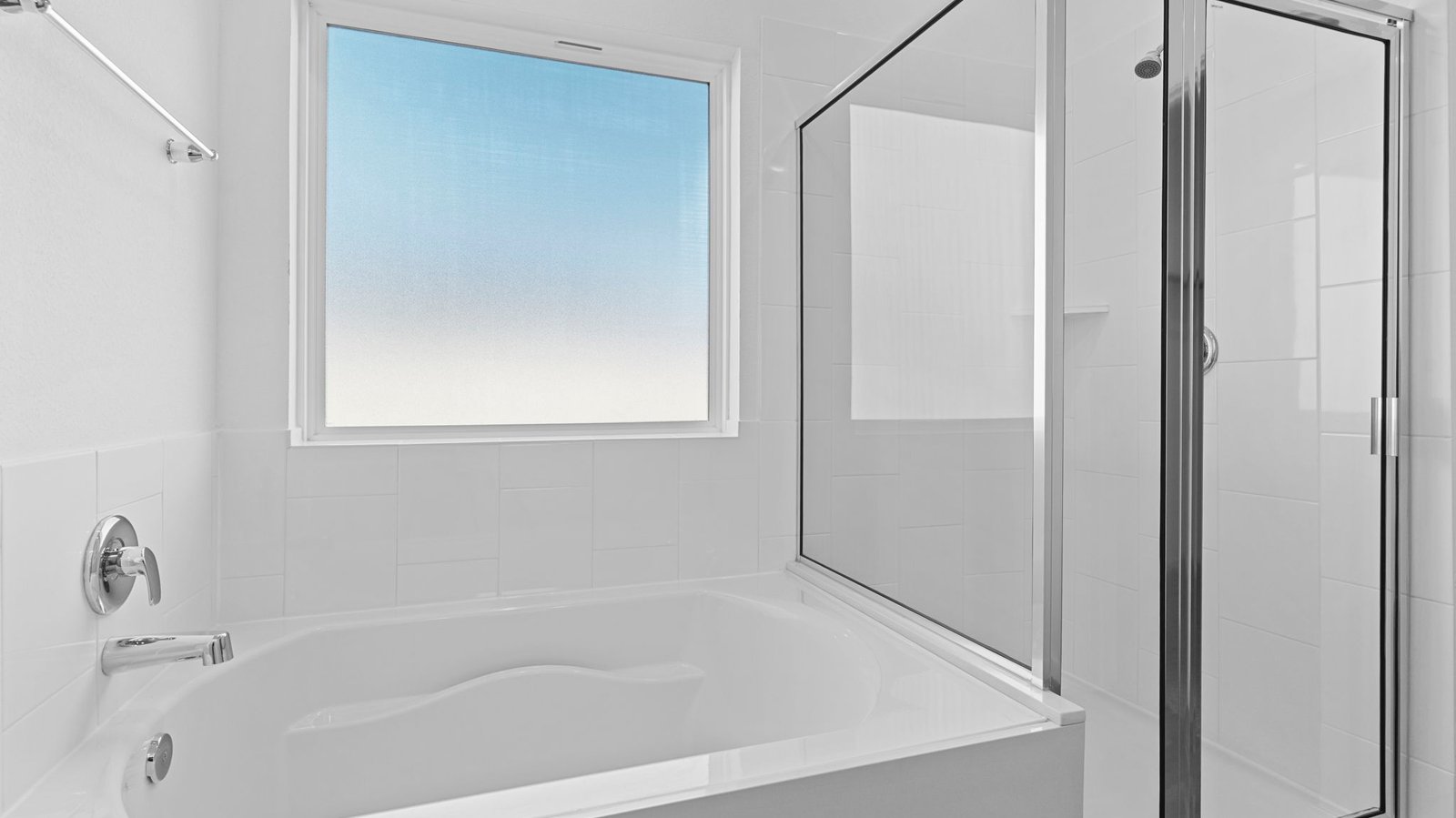 primary bathoom with garden tub, standing shower and dual vanity sinks