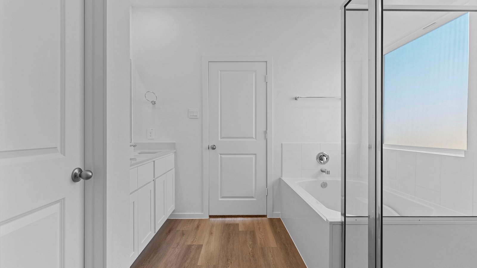 primary bathoom with garden tub, standing shower and dual vanity sinks