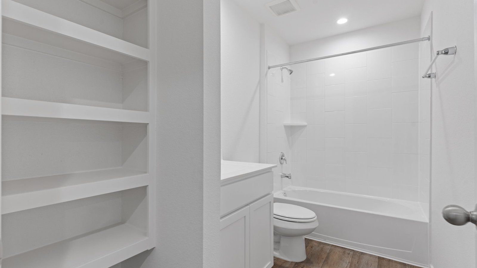 full secondary hall bath with tub shower combo and storage shelves