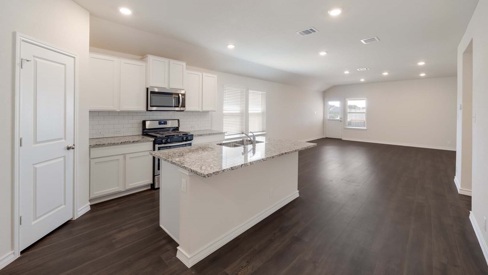 Spacious open concept kitchen with island and counter prep space