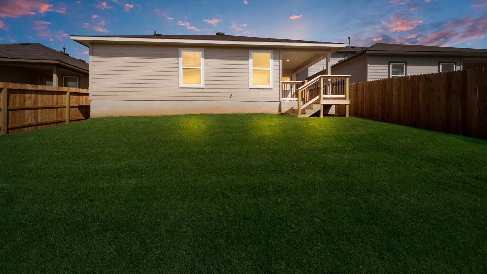 Covered back patio area overlooking private fenced-in backyard