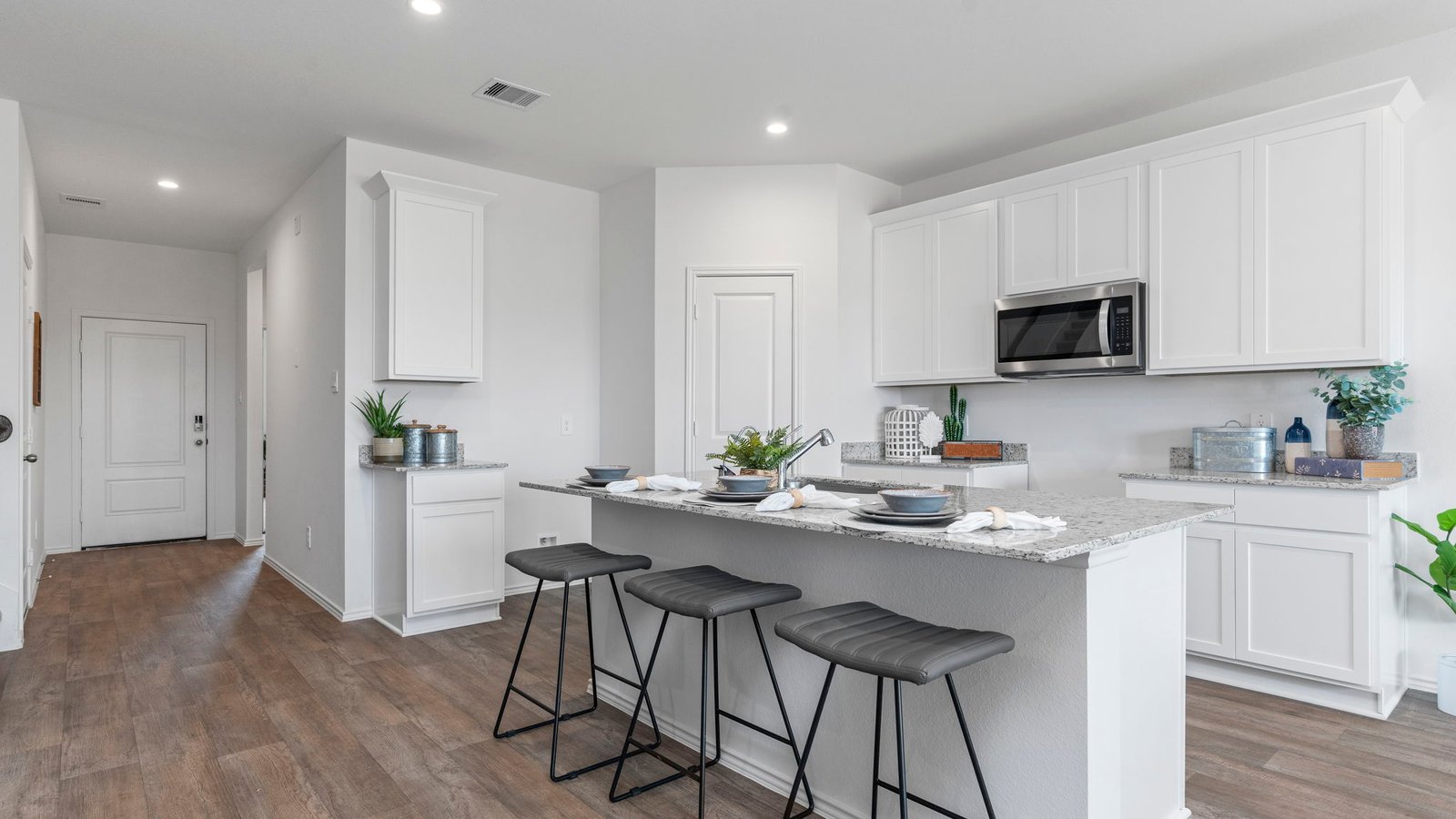 Kitchen with stainless steel appliances, shaker style cabinets, and elevated finishes