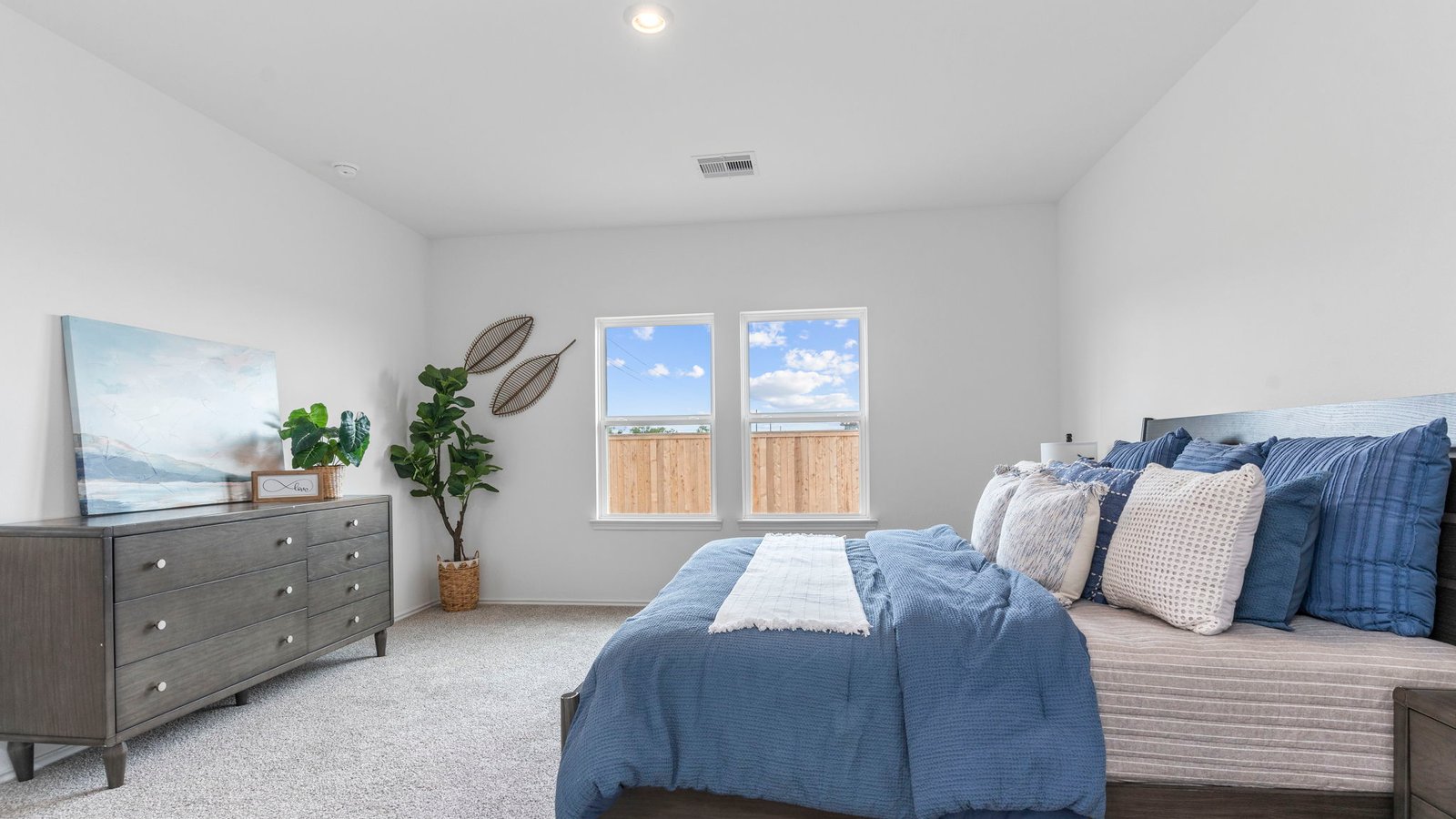 Primary bedroom with plush carpet floors and light allowing double windows