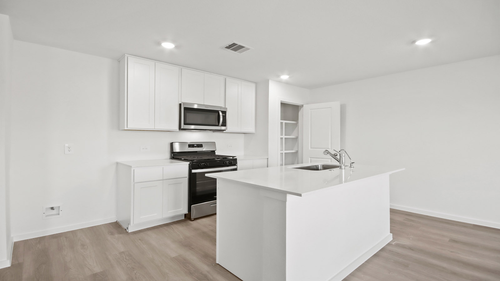 Spacious open concept kitchen with island and counter prep space