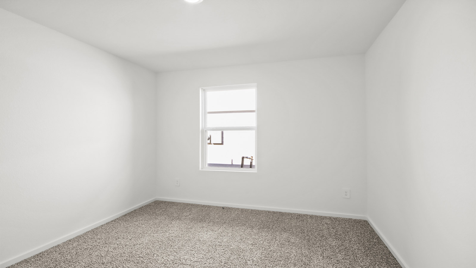 Guest bedroom 4 with plush carpet and side window