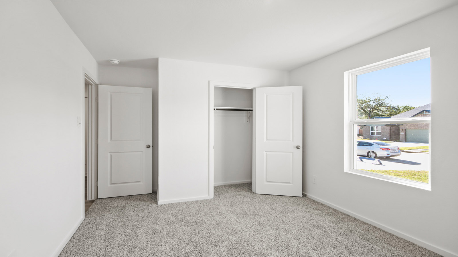 Guest bedroom 4 with plush carpet and side window