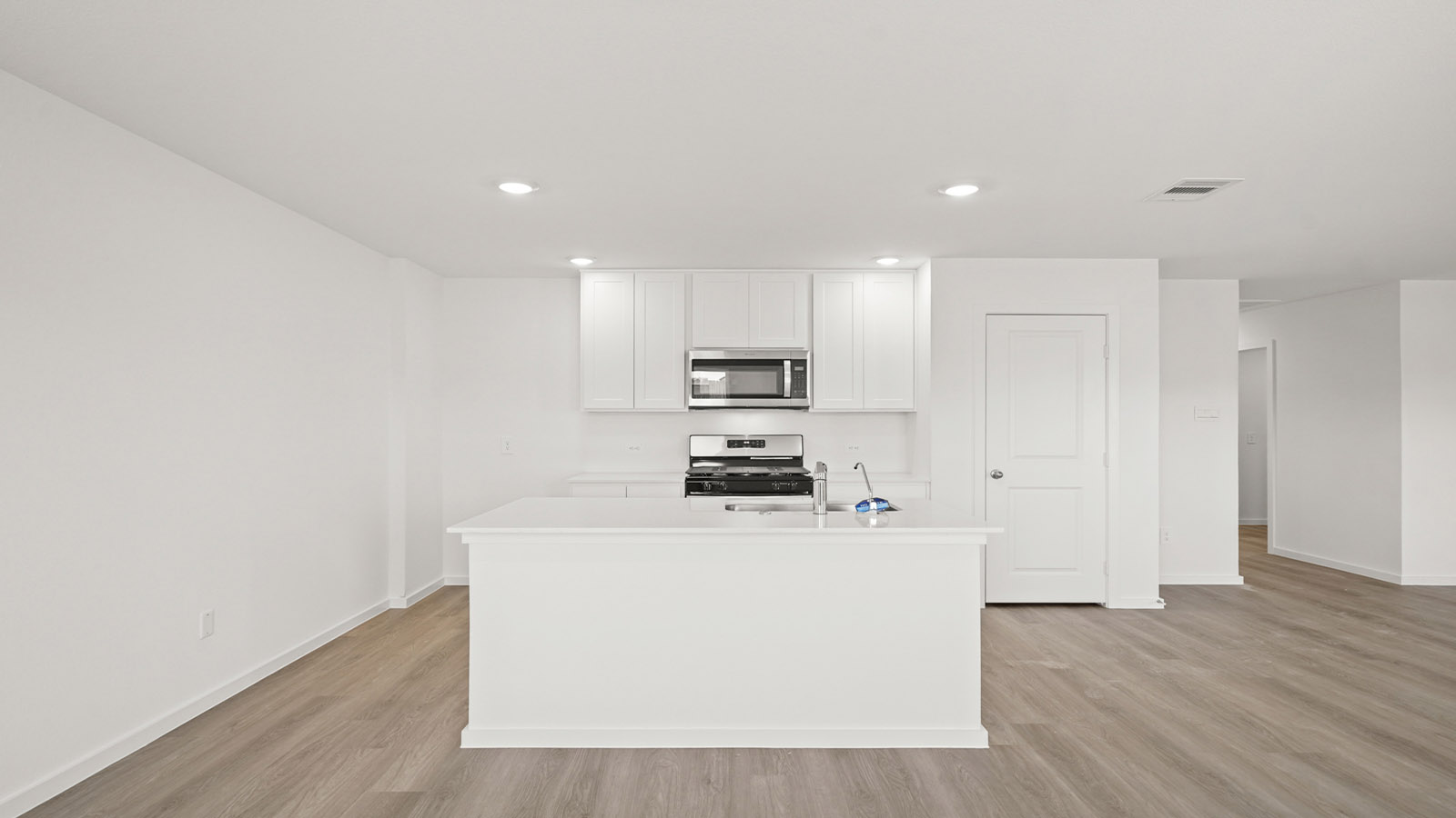 Spacious open concept kitchen with island and counter prep space