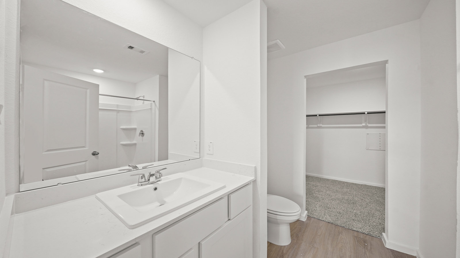 Private attached primary bathroom with built in vanity