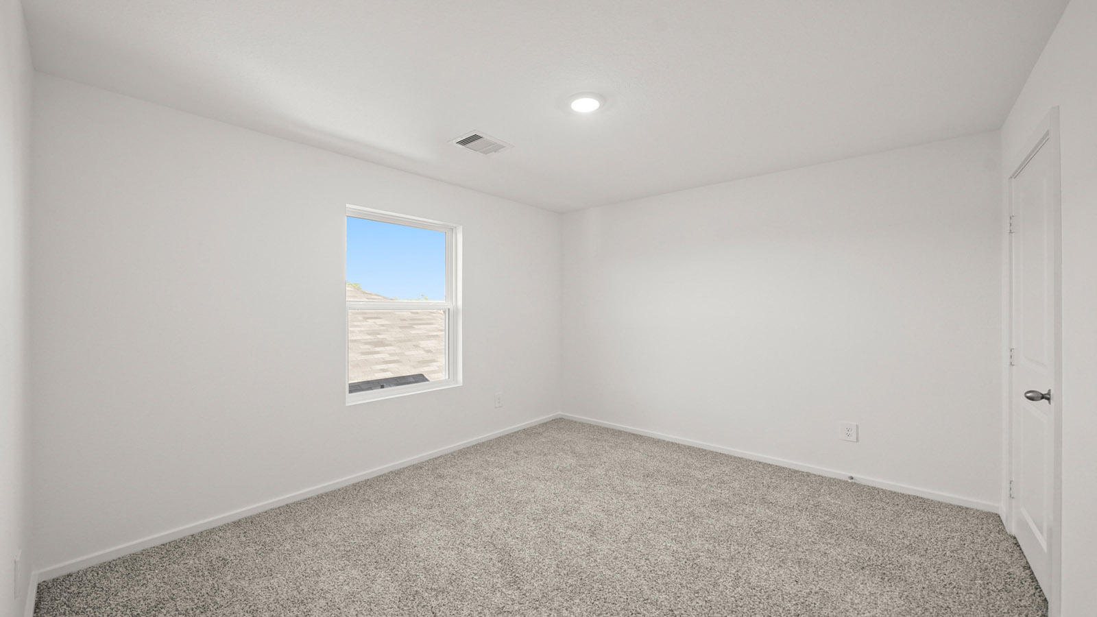 Guest bedroom 1 with front windows and ample natural light