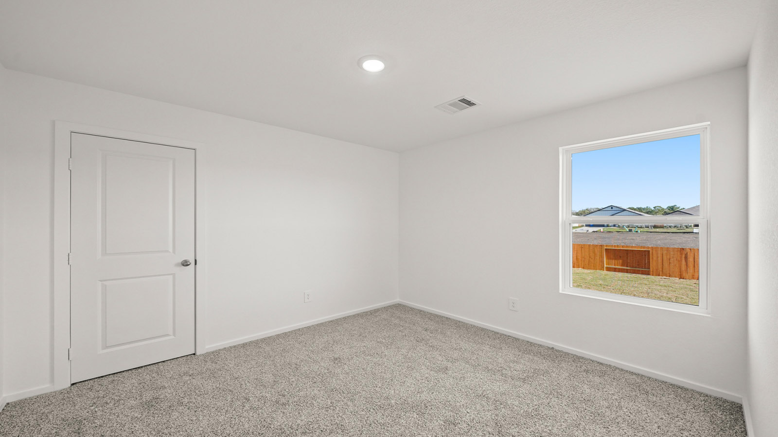 Guest bedroom 2 with side window and plush carpet floor