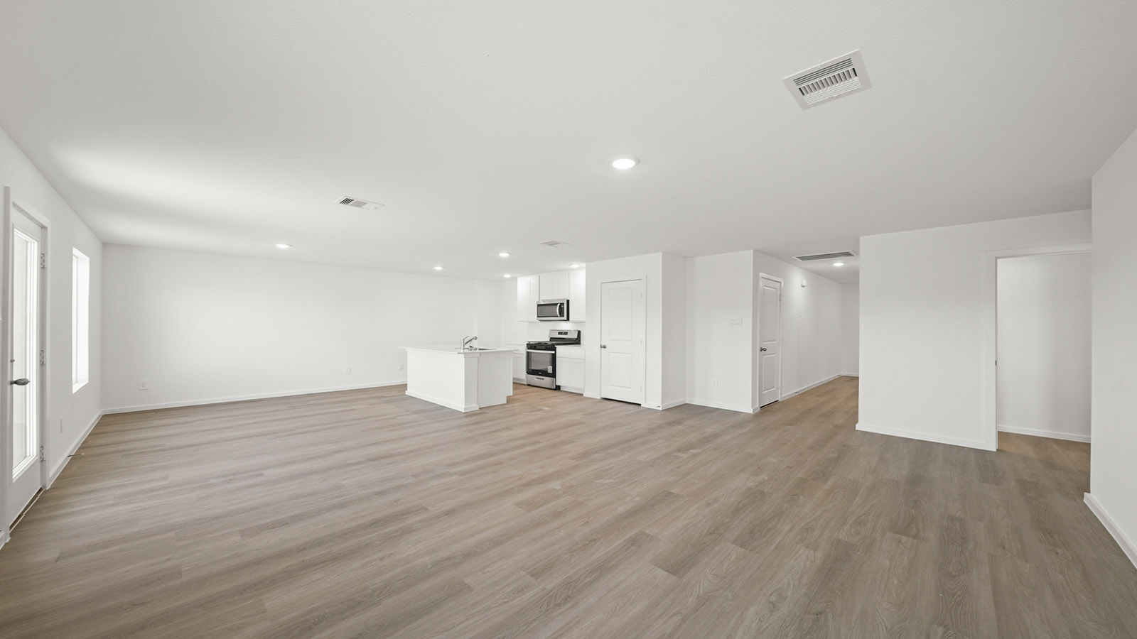 Spacious living and family room space with light allowing windows